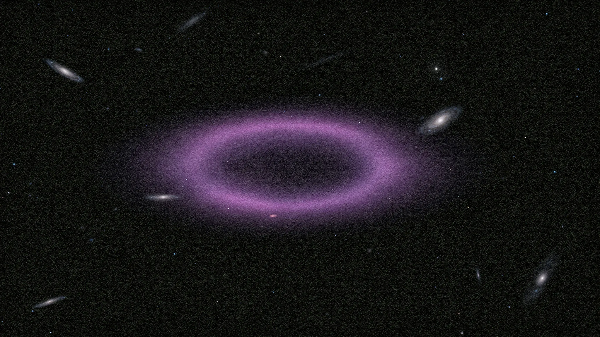 A faint, flattened ring of diffuse gas with no stars inside, among scattered distant galaxies, lit in deep violet.