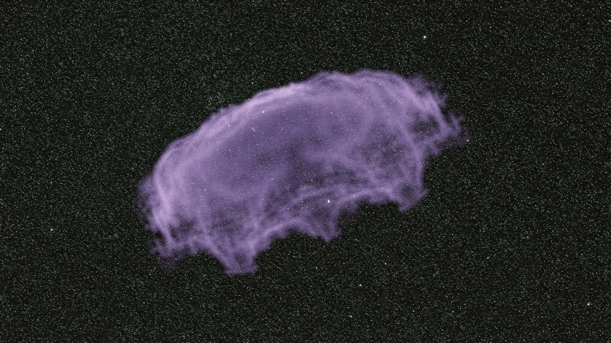 A diffuse, irregular violet cloud of gas against a dense field of stars that shine through it.