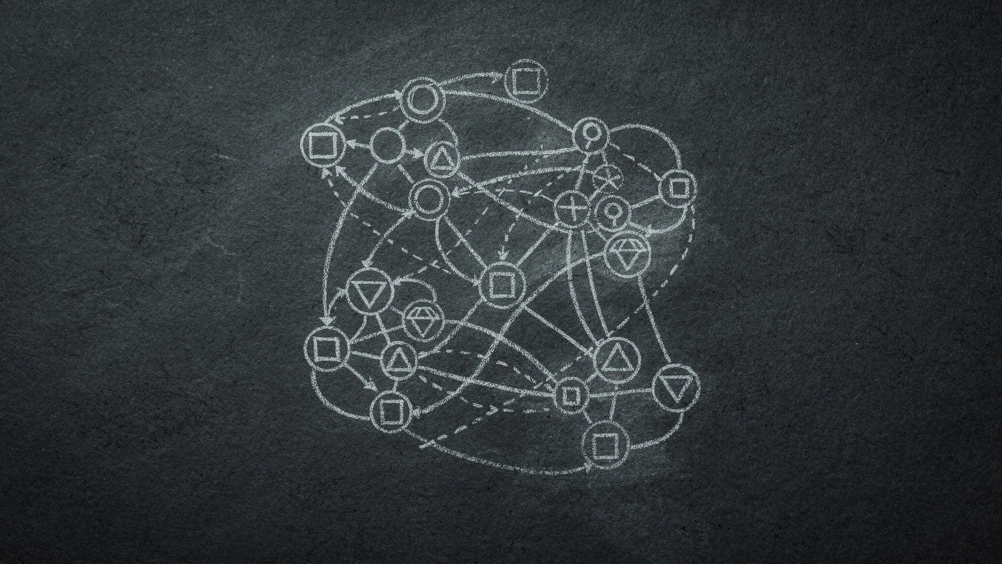 A chalk-drawn network of circled points marked with small shapes, joined by solid and dashed lines, on dark paper.