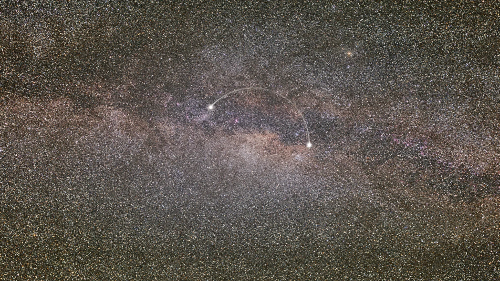 A dense star field of the Milky Way, with a thin bright arc joining two stars near the centre.